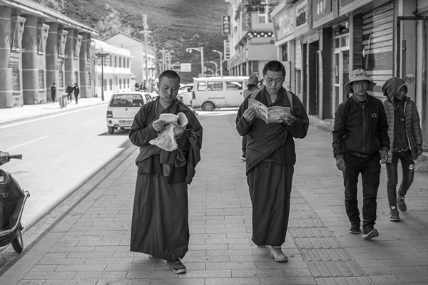 Chinese monks multitask by reading books and walking at the same time. 