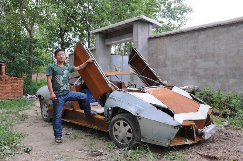 Wang Jian poses with his scrappy homemade Lamborghini